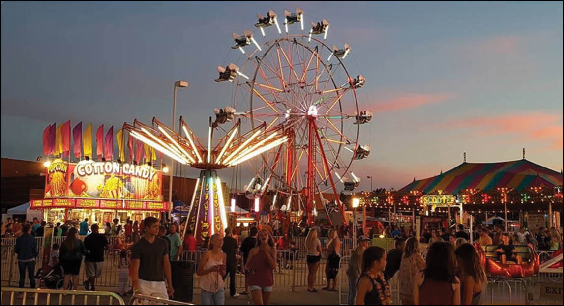A lively carnival scene at dusk with people walking, a brightly lit cotton candy stand, a spinning ride, a Ferris wheel, and a colorful tent in the background. Description generated by AI