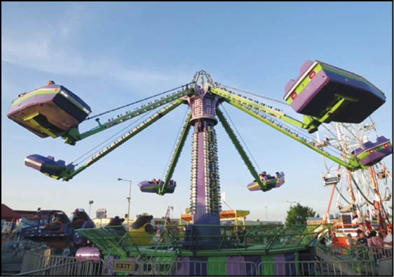 A colorful amusement park ride with multiple swinging seats elevated in the air against a clear blue sky. Description generated by AI