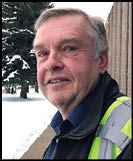 A man wearing a white shirt and black jacket. Description generated by AI